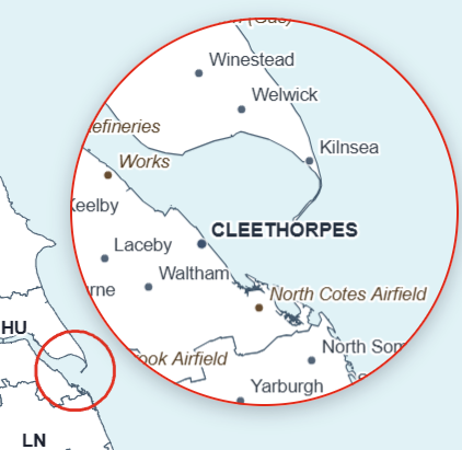 Circular inset map enlarging a detailed coastal area